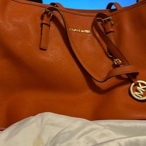 It’s an orange Michael Kors bag